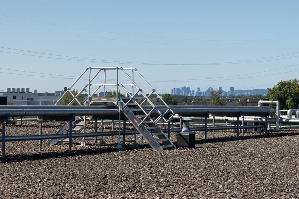 A rooftop crossover bridge to cross over pipes.
