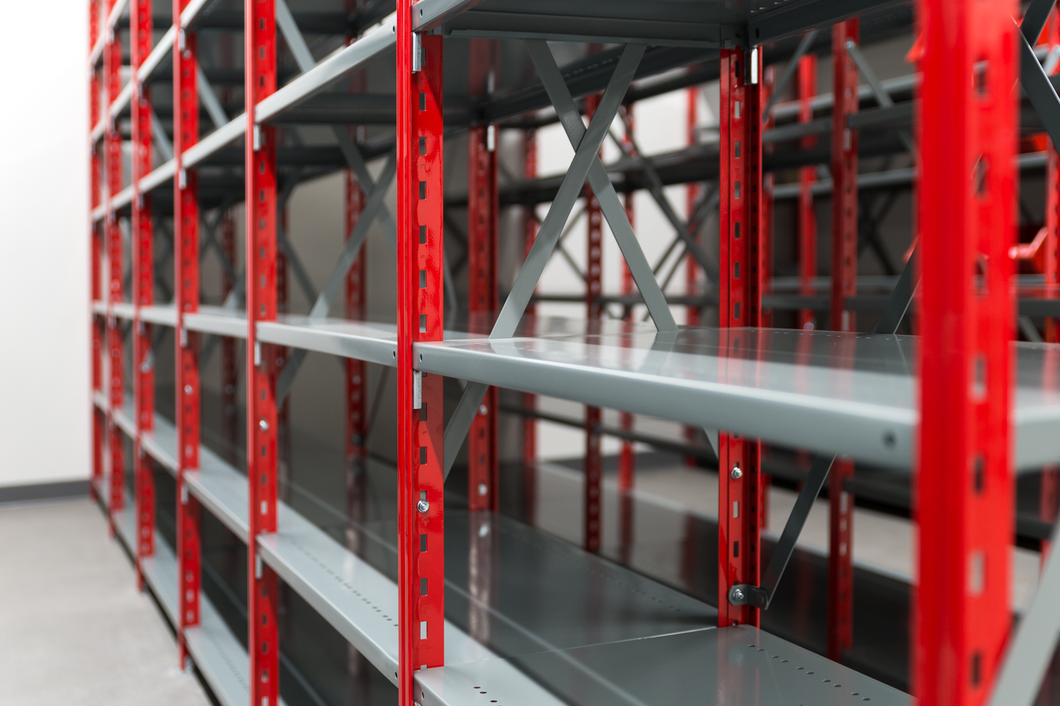 Industrial metal shelving system with adjustable steel shelves in a warehouse storage environment