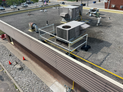 Freestanding guardrail securing a ventilation unit.