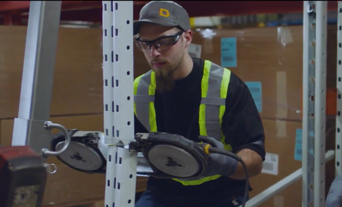 A man repairing a damaged pallet rack.